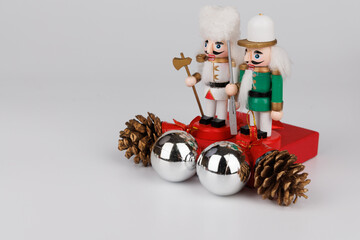 Whimsical Nutcracker Duo on a Red Box with Silver Ornaments and Pine Accents