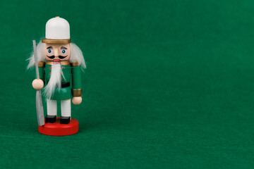 Charming Nutcracker with Original Hair Set Against a Rich Green Backdrop