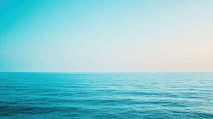 Clear blue sky and tranquil ocean with simple gradient reflecting serenity and calm
