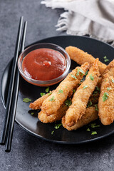 Breaded Torpedo shrimps on black slate background