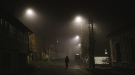 Woman walking alone on a foggy night in the city © 4Max