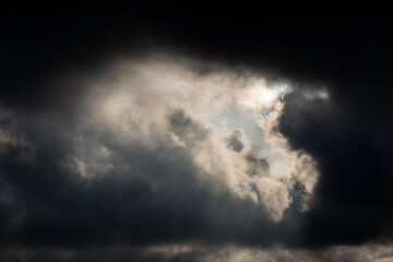 Sky with dark and dramatic sunset clouds. Natural background.