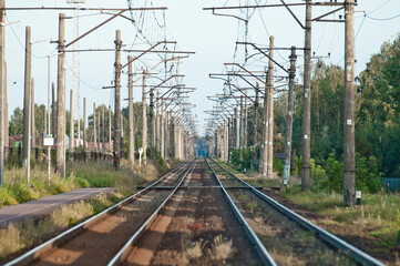 In the photo there is an electrified railway without trains