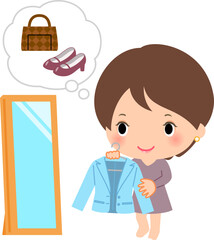 服のコーディネートを考えている女性