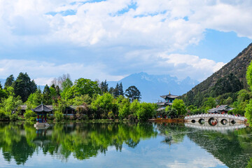 Fototapeta premium Chinese Traditional Pagoda, Pavilion and Arch Bridge at the Black Dragon Pool Park, Lijiang Old Town 