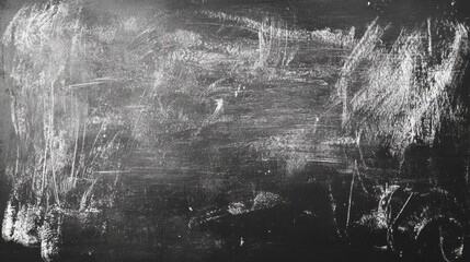 A close-up of a worn black chalkboard surface showing scratches and smudges, ideal for educational themes.