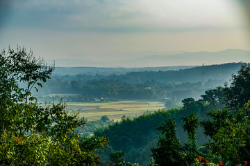 Serene landscape view of rolling hills and fields in early morning light nature photography tranquil environment scenic perspective