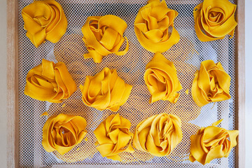Fresh Italian Pappardelle Pasta on the sieve. Top view