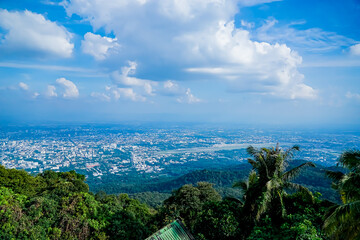 Aerial view of scenic cityscape overlooking lush mountains urban environment nature's beauty cloudy skies