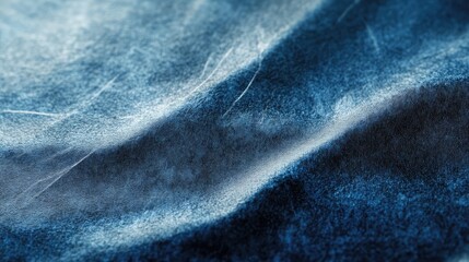 Close-up of a textured blue fabric, showcasing soft folds and a smooth, inviting appearance.
