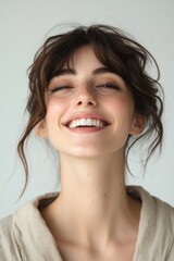 Woman smiling with eyes closed