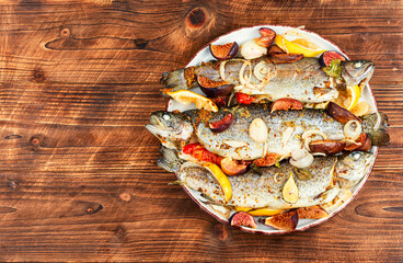 Whole grilled fish served with figs.