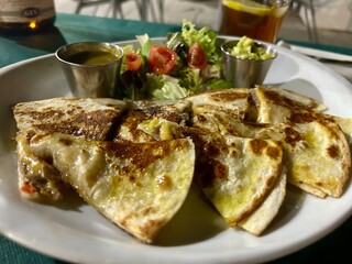 A plate of Mexican food at night 