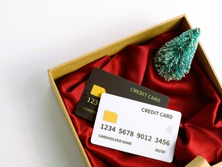 Credit card showcased on red cloth base in a minimalist opened cardboard  gift box, isolated...