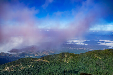 Exploring the breathtaking mountain view above the clouds in nature's majesty high altitude panoramic perspective