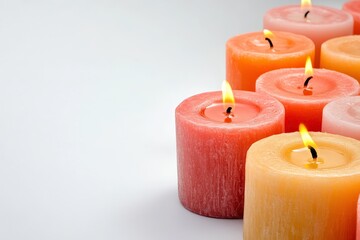 A tranquil arrangement of colorful candles with flickering flames, creating a warm and inviting atmosphere, perfect for relaxation, meditation, or special occasions.