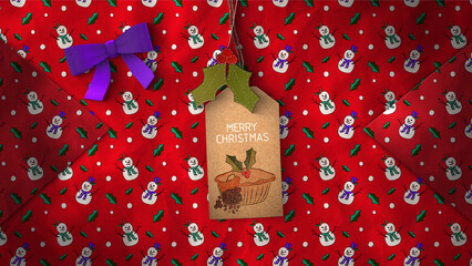 A festive background of Christmas wrapping paper and gift tag.