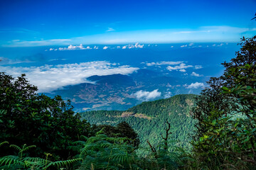 Scenic mountain view overlooking clouds nature landscape adventure travel lush environment panoramic perspective serenity