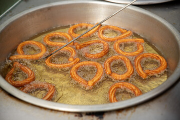 Turkish Churros, very popular street foods or street desserts in Turkey, Halka Tatlisi circular dessert fried in oil and sweetened with honey syrup