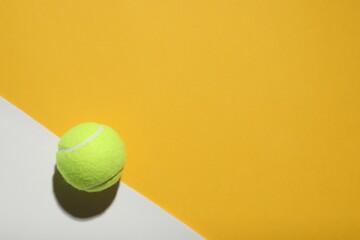 Tennis ball on color background