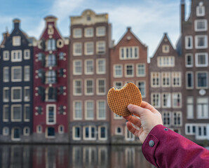 Delicious Stroopwafel in hand, tasting traditional dutch treat in Amsterdam