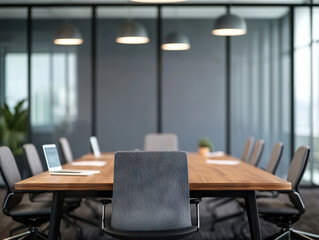modern conference room with large wooden table and ergonomic chairs, featuring laptops and plants, creating professional atmosphere