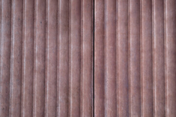 Fototapeta premium Corrugated metal roller shutter texture. Red steel door for background.