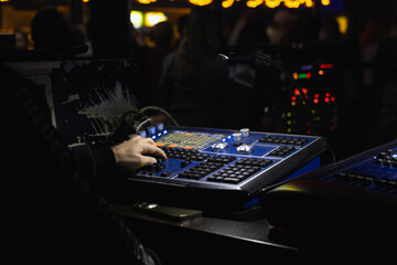 Sound engineer works at a mixing console, close-up