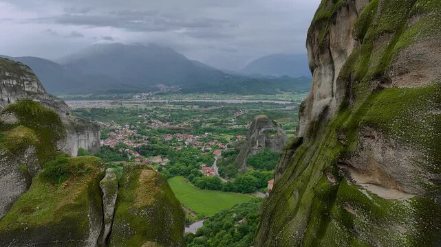 Drone flight among cliffs of the Meteora Valley and the small picturesque towns of Kastraki and Kalampaka at their foot, Greece