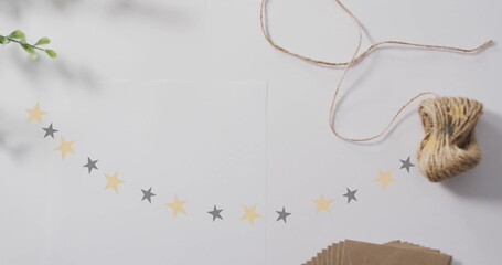 Fototapeta premium Stars image over crafting materials on white background