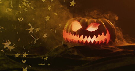 Fototapeta premium Glowing jack lantern with stars image over smoky background