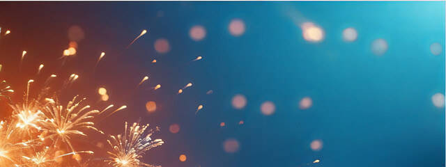 Obraz premium Bright fireworks light up the night sky, creating stunning visual displays of orange and gold against a blue backdrop. This vibrant celebration captivates viewers with dazzling bursts