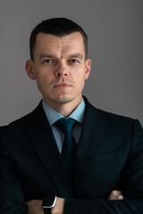 Successful smiling ambitious caucasian european businessman lawyer in suit standing in light office with laptop and phone