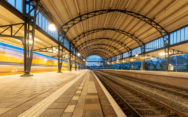 Long exposure of dutch train passing through station Haarlem, travelling by train in The Netherlands