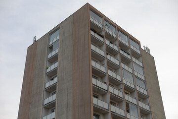 A tall building featuring numerous windows and balconies, creating a striking facade in the urban...