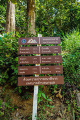 Hiking trail signage forested area informational content natural environment close-up view outdoor navigation tips