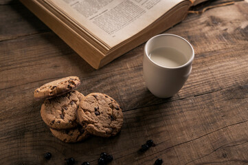 Home made Chocolate Cookies with Blueberries and Milk on Wooden table
