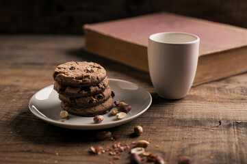 Home made Chocolate Cookies with Blueberries and Milk on Wooden table