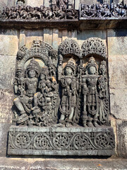 Ornate wall panel reliefs depicting,from left, Vishnu with his consort Lakshmi, Paravati and Shiva. Ranganayaki, Andal, temple, Chennakesava temple complex, Belur, Karnataka, India. West wall. 