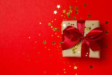 Beautiful gift box tied with bow on color background 