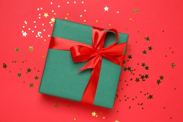 Beautiful gift box tied with bow on color background 