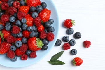 Different fresh ripe berries in bowl on the table