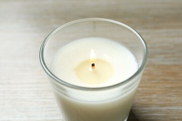 Scented candle with on wooden background 
