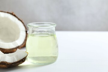 Jar of coconut oil on wooden background