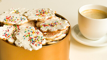 Cup of coffee with homemade Christmas cookies in bowl on the table.