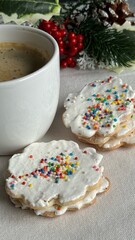 Cup of coffee with delicious homemade Christmas cookies on the table with decorative Christmas background.