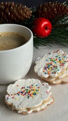 Cup of coffee with delicious homemade Christmas cookies on the table with decorative Christmas background.