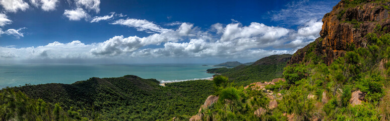 The coastal landscape features lush greenery and stunning azure waters for an incredible view