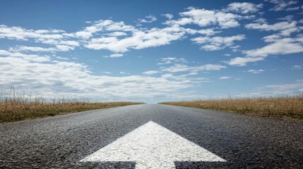 straight road with an arrow painted on it leading to the horizon, symbolizing goal setting and achievement