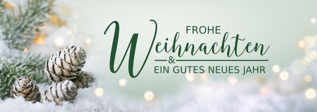 Christmas greeting card German text - Merry Christmas and Happy New Year - Frosty Xmas scene, Natural Winter background with snow and golden lights - Panorama, banner, header for advertisement 